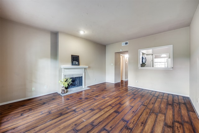 unfurnished living room with dark hardwood / wood-style floors