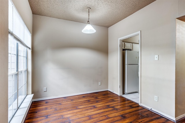 empty room featuring hardwood / wood-style floors and a textured ceiling