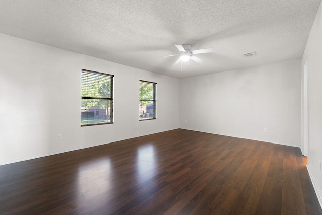 spare room with dark wood-type flooring, ceiling fan, and a textured ceiling