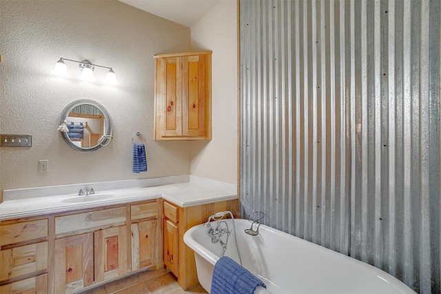 bathroom featuring a tub to relax in, tile patterned floors, and vanity