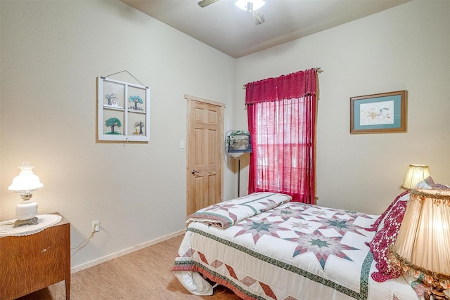 bedroom with hardwood / wood-style floors and ceiling fan