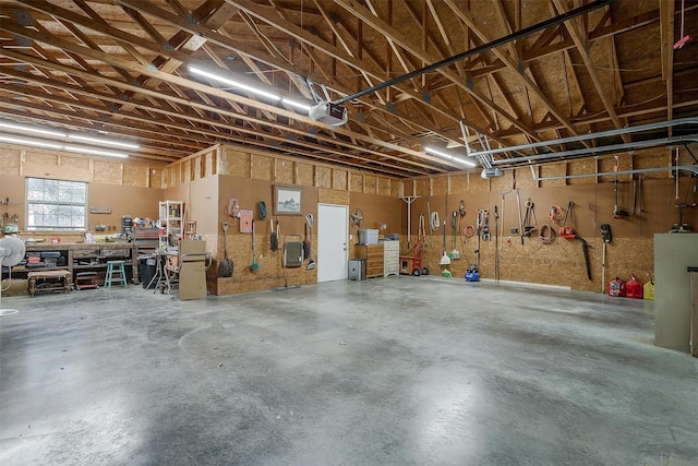 garage with a workshop area and a garage door opener