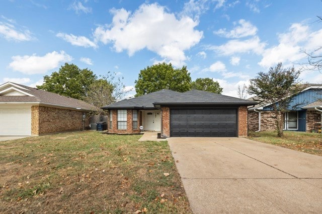 ranch-style home featuring a front yard and a garage