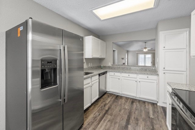 kitchen with dark hardwood / wood-style floors, white cabinets, appliances with stainless steel finishes, a textured ceiling, and ceiling fan