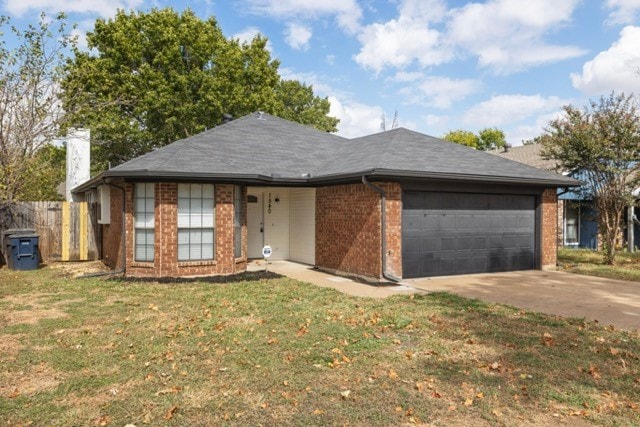 ranch-style home featuring a garage and a front lawn