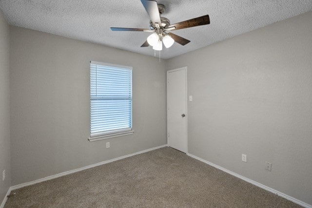 unfurnished room with a textured ceiling, carpet, and ceiling fan