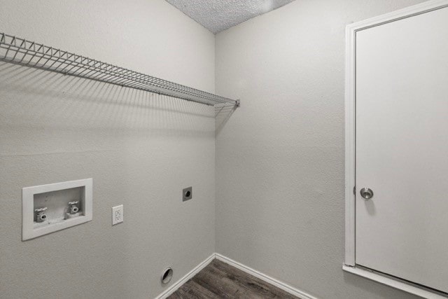 washroom with a textured ceiling, electric dryer hookup, washer hookup, and dark hardwood / wood-style floors