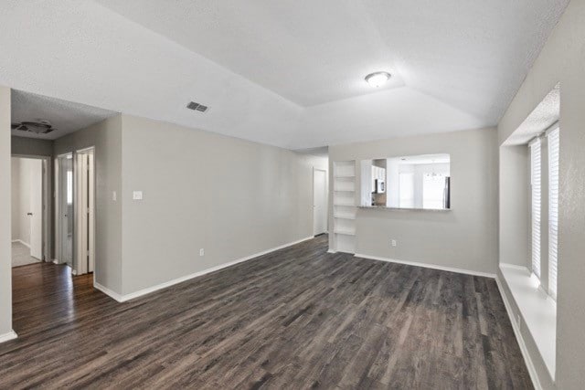 empty room with dark hardwood / wood-style floors