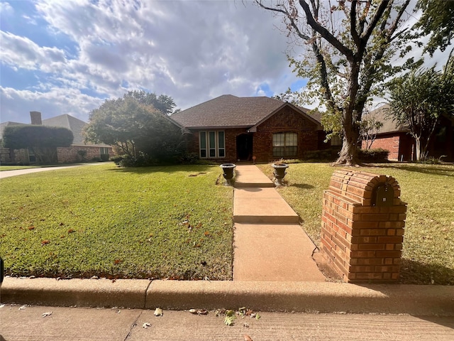 ranch-style home featuring a front yard