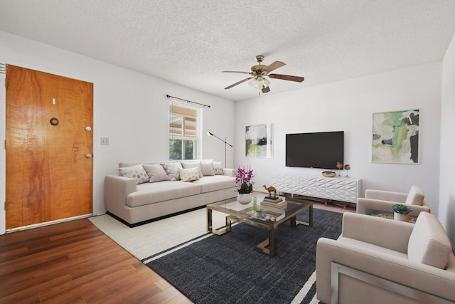 living room with hardwood / wood-style floors, a textured ceiling, and ceiling fan