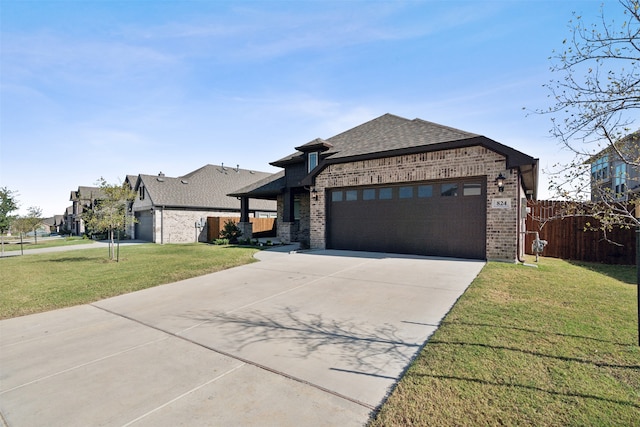 view of front of property featuring a front yard and a garage