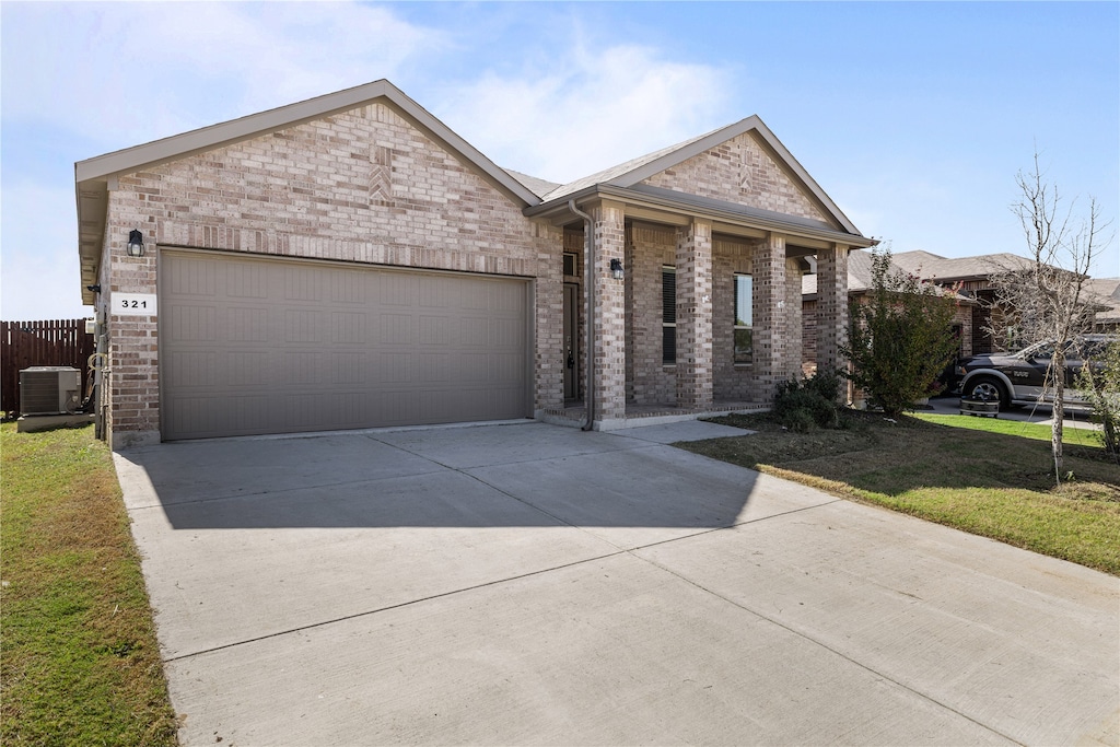 view of front facade with cooling unit, a garage, and a front lawn