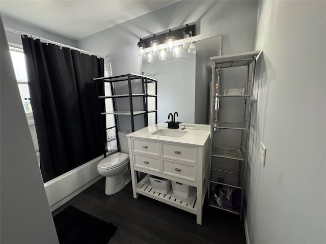 full bathroom featuring vanity, hardwood / wood-style floors, toilet, and shower / tub combo with curtain