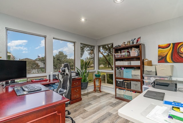 office area with light hardwood / wood-style floors