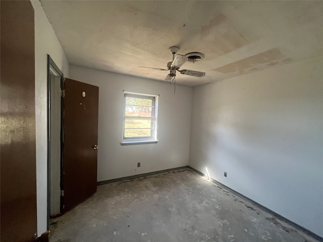 spare room featuring concrete floors and ceiling fan