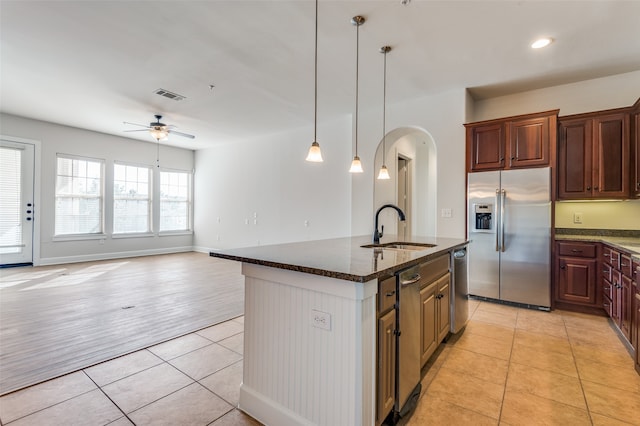 kitchen with light hardwood / wood-style flooring, stainless steel appliances, sink, pendant lighting, and ceiling fan