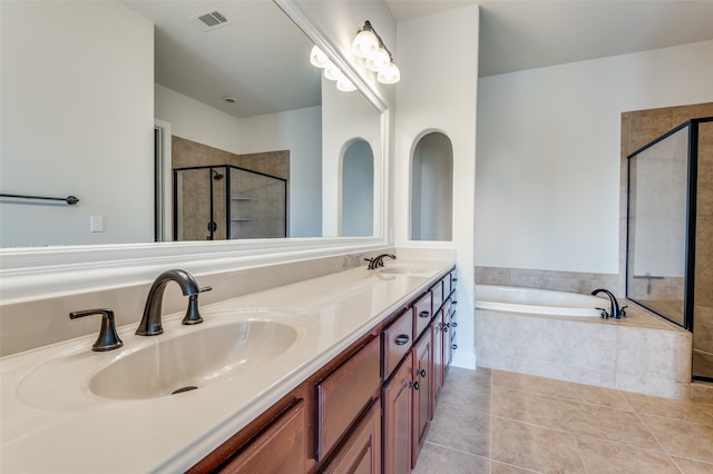 bathroom with vanity, independent shower and bath, and tile patterned floors