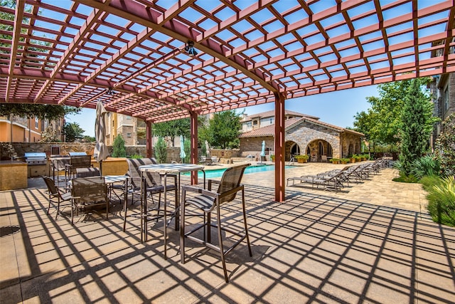 view of patio / terrace with a pergola, area for grilling, and a community pool