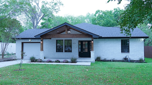 view of front of house featuring a front yard and a garage