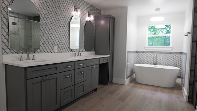 bathroom featuring vanity, tile walls, separate shower and tub, and hardwood / wood-style floors