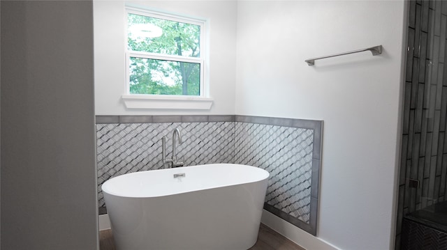 bathroom featuring a bathing tub and tile walls