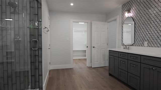 bathroom with vanity, hardwood / wood-style flooring, and a shower with shower door