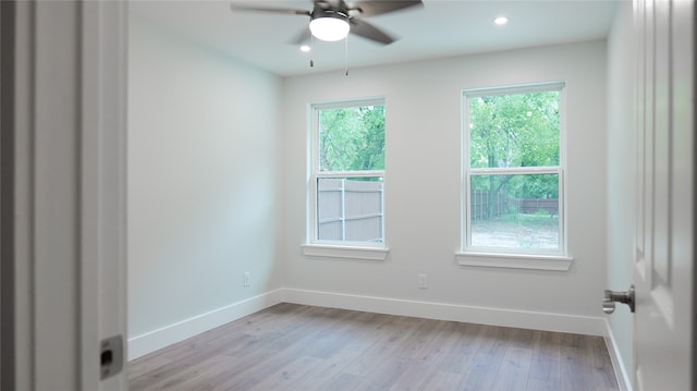 empty room featuring light wood-type flooring and ceiling fan