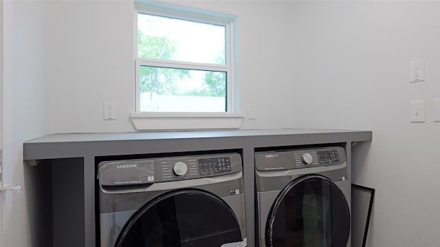 clothes washing area with separate washer and dryer