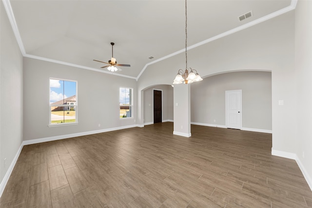 unfurnished living room featuring crown molding, vaulted ceiling, wood-type flooring, and ceiling fan with notable chandelier