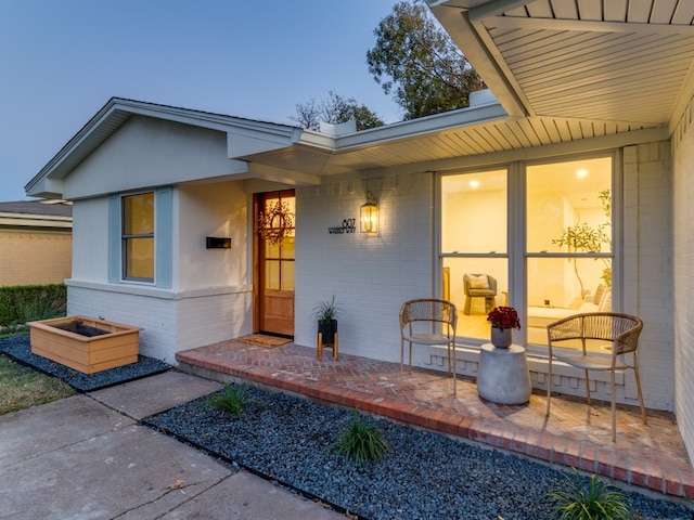 exterior entry at dusk with a patio