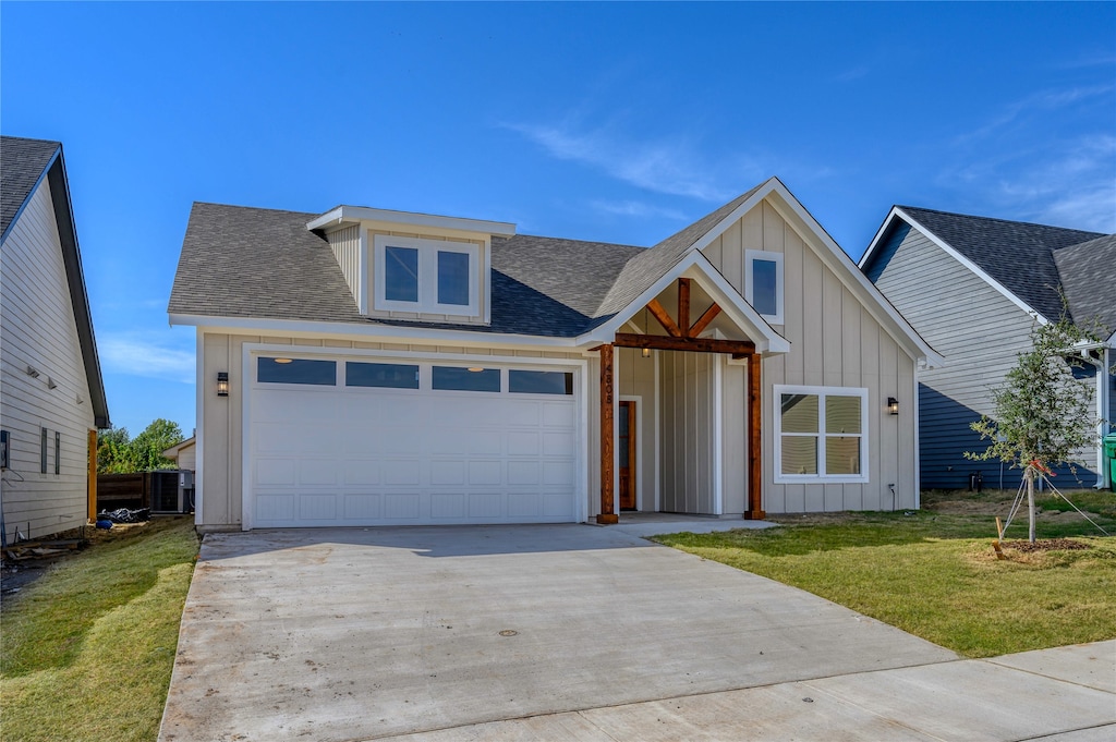 view of front of house featuring a garage and a front lawn