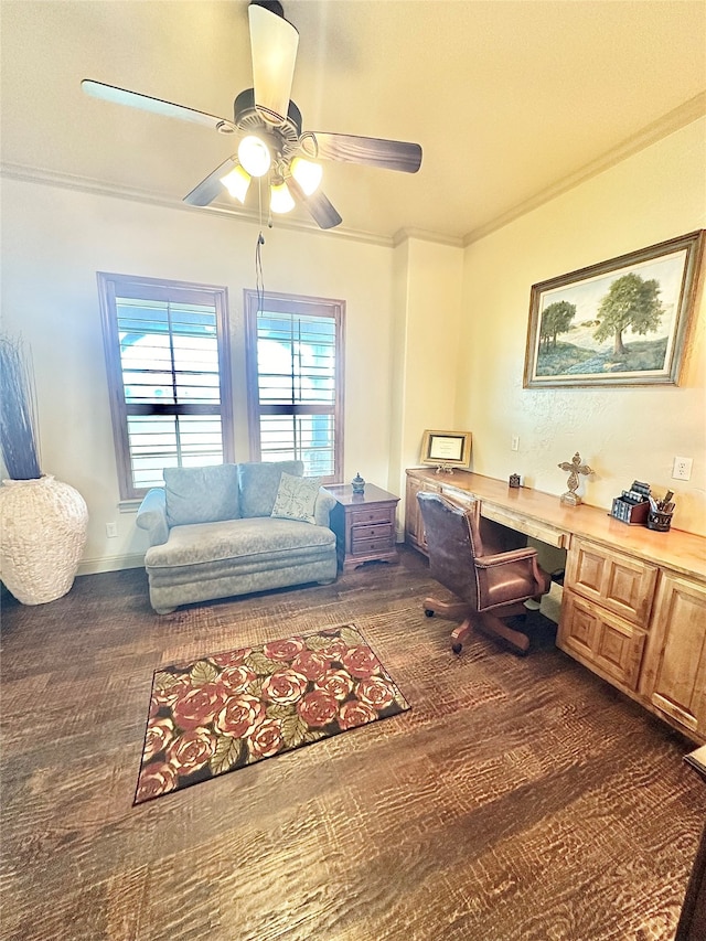 office area with built in desk, ceiling fan, dark wood-type flooring, and ornamental molding