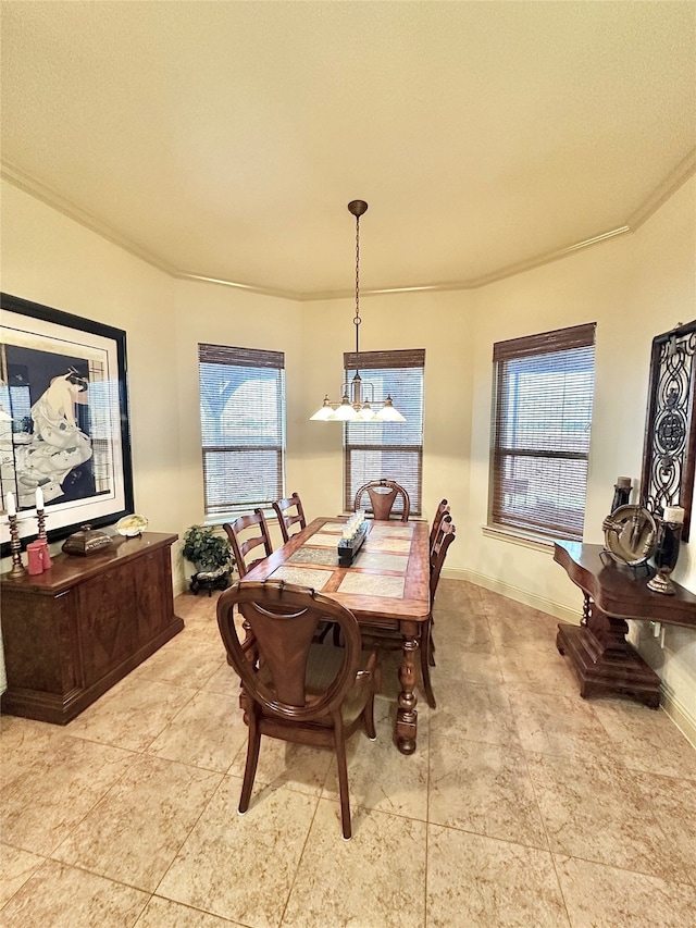 dining area featuring a notable chandelier, ornamental molding, and a healthy amount of sunlight