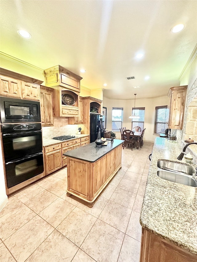 kitchen with a kitchen island, ornamental molding, black appliances, sink, and decorative light fixtures