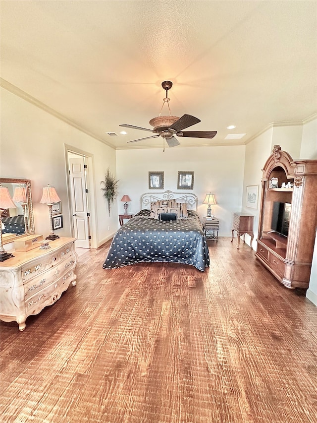 bedroom featuring ceiling fan, hardwood / wood-style flooring, and crown molding