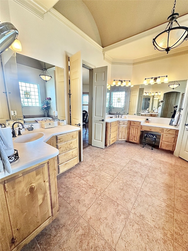 bathroom with vanity, crown molding, a tub, and plenty of natural light