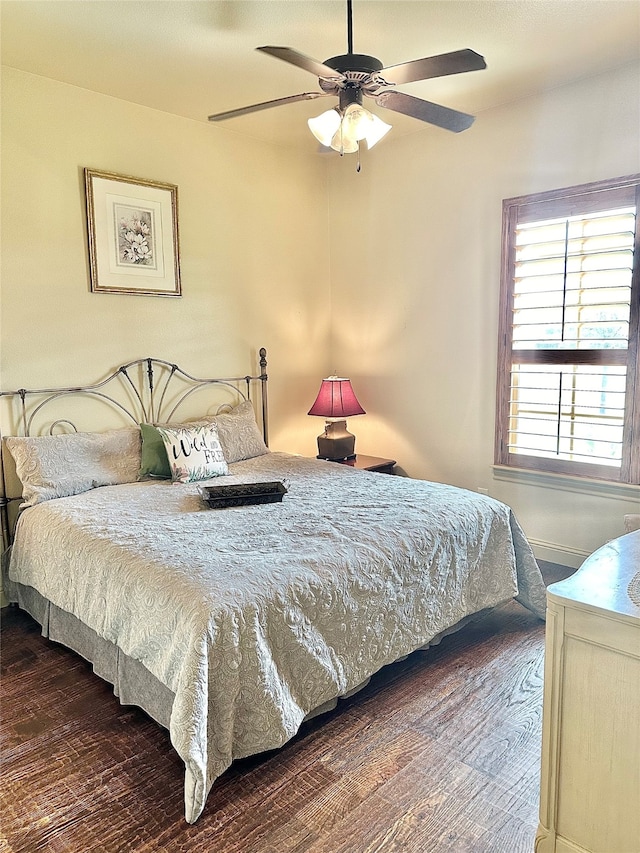 bedroom featuring ceiling fan and dark hardwood / wood-style flooring