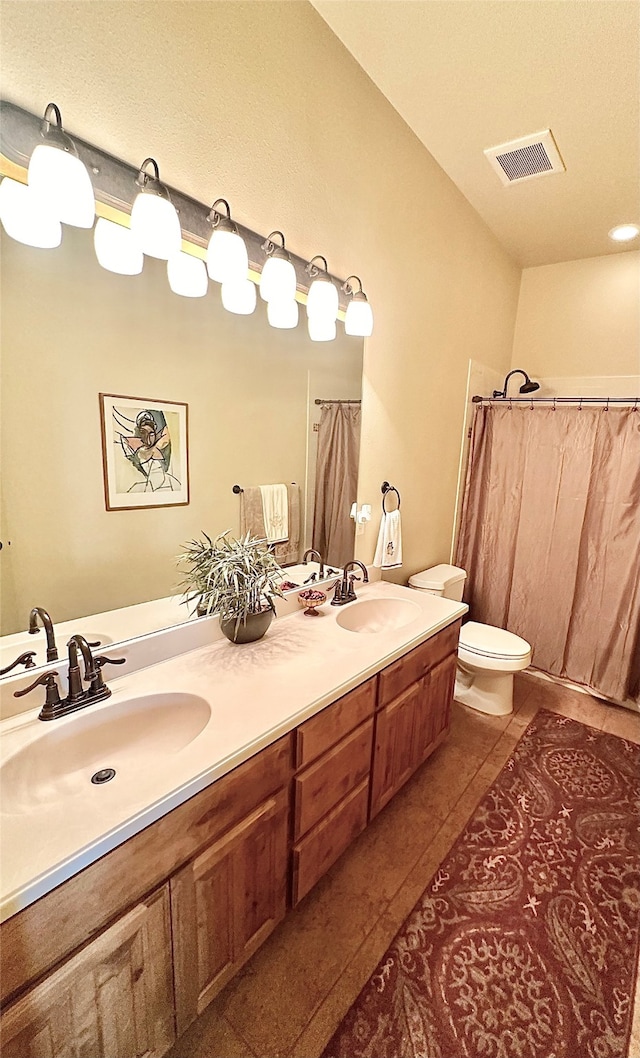 bathroom featuring vanity, toilet, tile patterned floors, and a shower with shower curtain