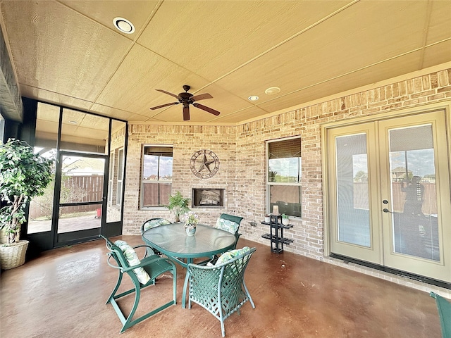 sunroom / solarium featuring french doors and ceiling fan