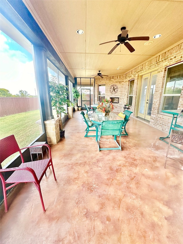 sunroom with a wealth of natural light and ceiling fan