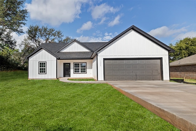 modern farmhouse featuring a front lawn and a garage