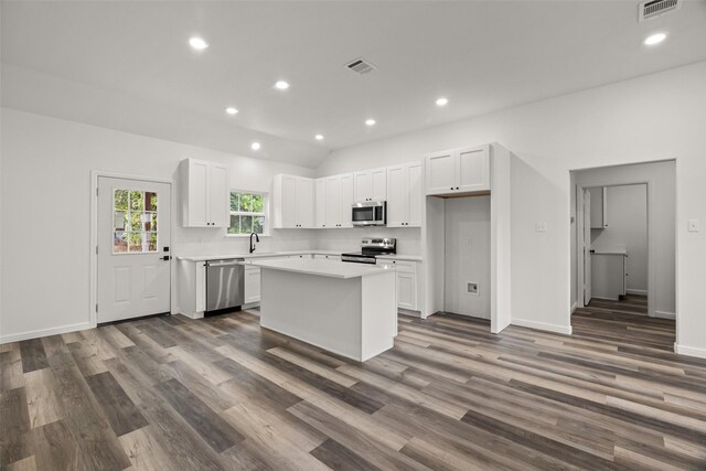 kitchen featuring sink, dark hardwood / wood-style floors, a kitchen island, white cabinetry, and stainless steel appliances