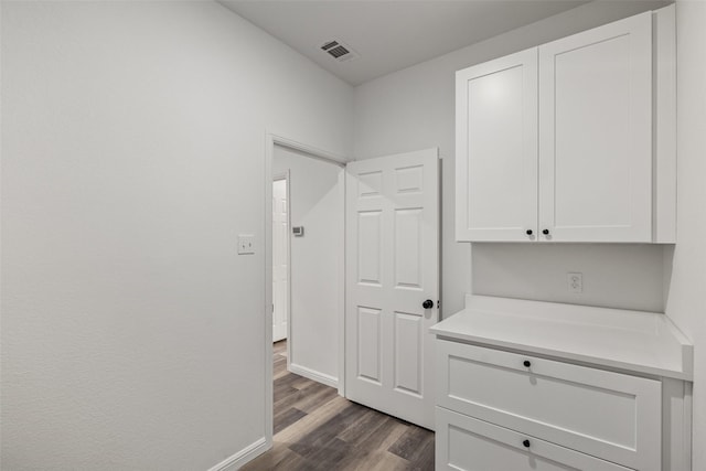 corridor featuring dark hardwood / wood-style flooring