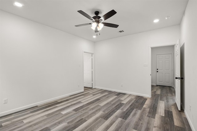 empty room with ceiling fan and hardwood / wood-style flooring