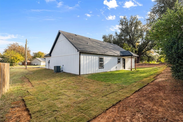 view of outbuilding with a yard and central AC unit