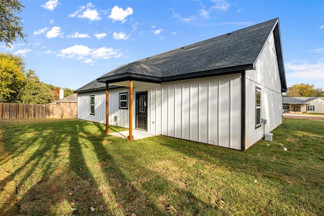 rear view of property with a lawn