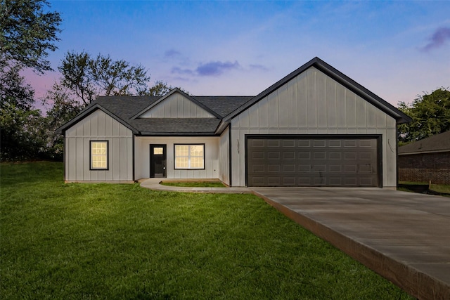 view of front of house with a yard and a garage