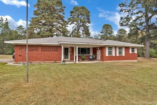 ranch-style house with a front lawn