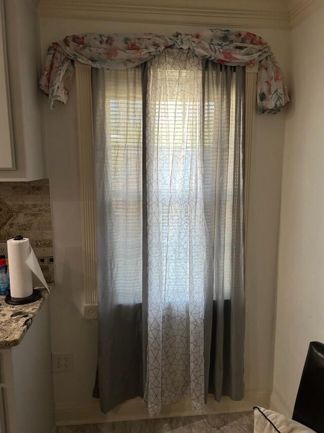 interior space with stainless steel refrigerator with ice dispenser, ornamental molding, washer and clothes dryer, and dark hardwood / wood-style floors