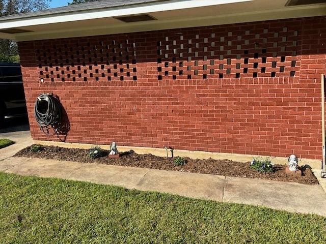 view of property exterior with brick siding